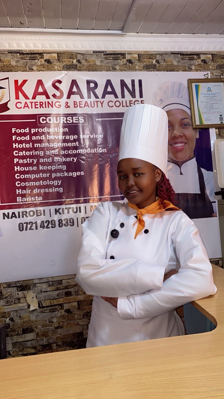 Trainees and a young guest in chef hats